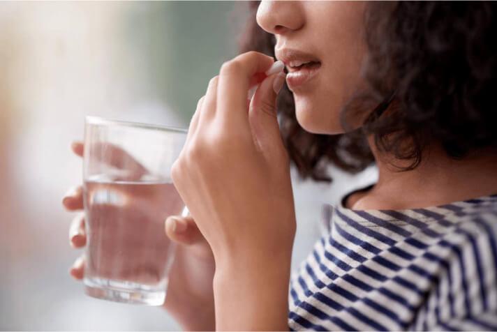 A woman taking dietary supplements A woman taking dietary supplements